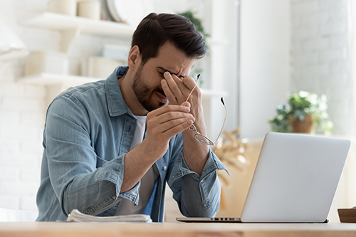 Man Experiencing Dry Eye Symptoms